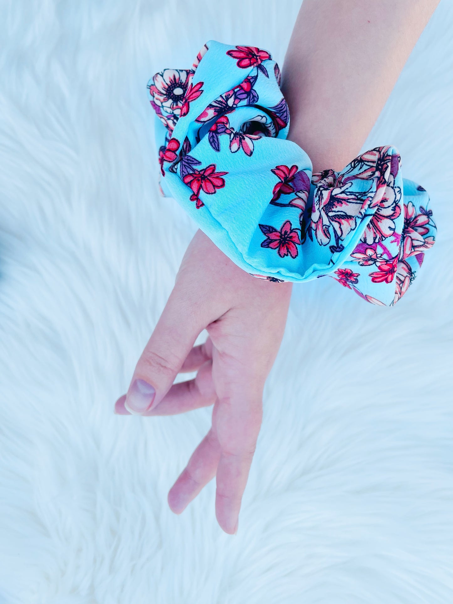 NEVAEH|EMI AND CO | blue and red floral scrunchie on wrist