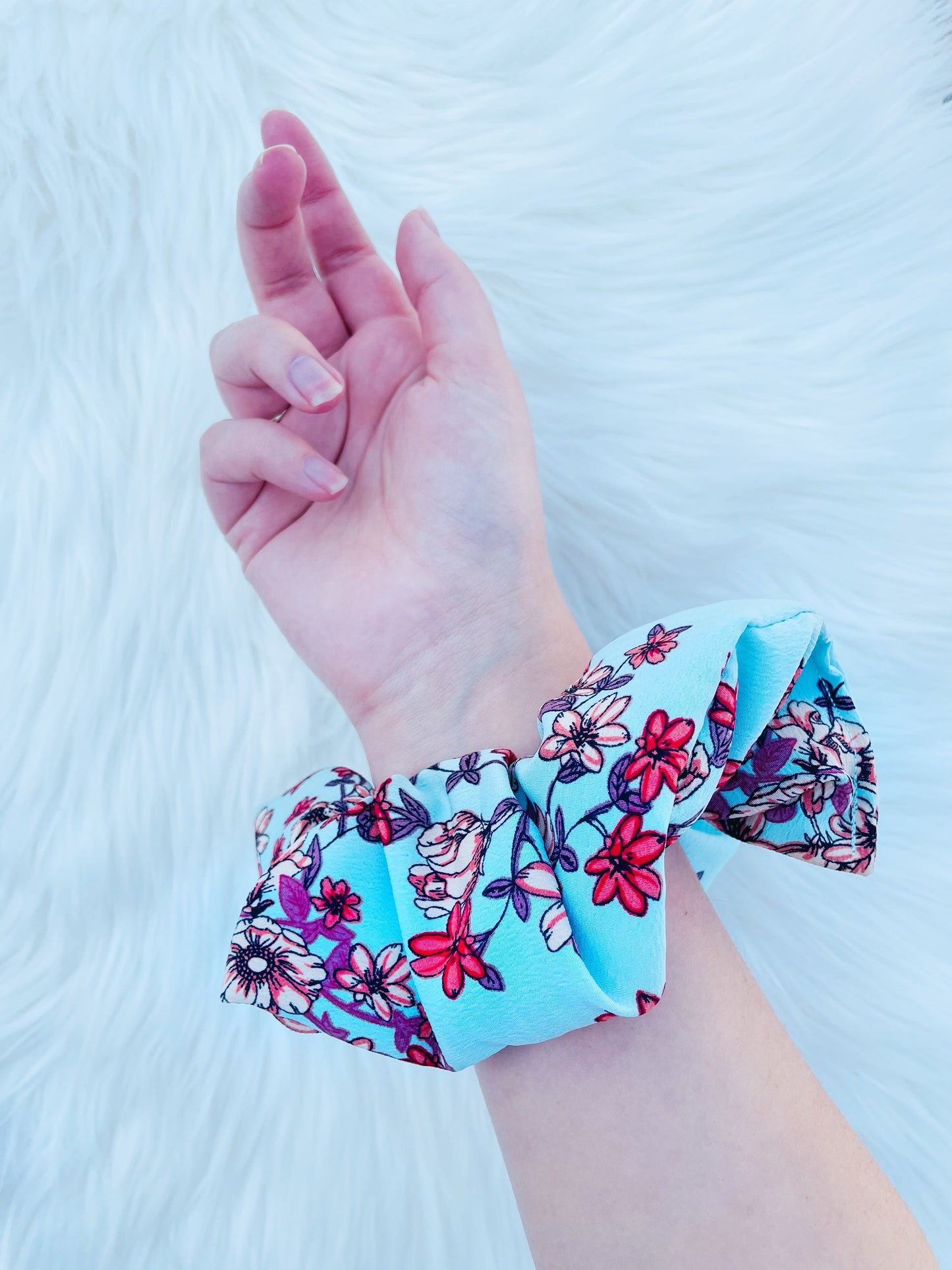 NEVAEH|EMI AND CO | blue and red floral scrunchie on wrist