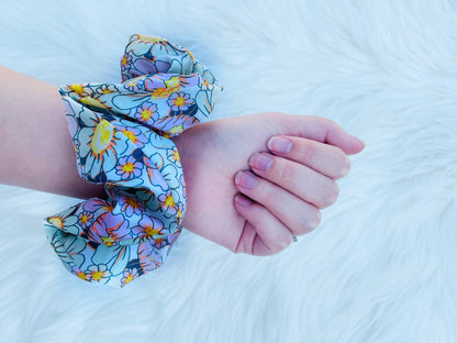 REAGAN| EMI AND CO | floral pink and green scrunchie on wrist 