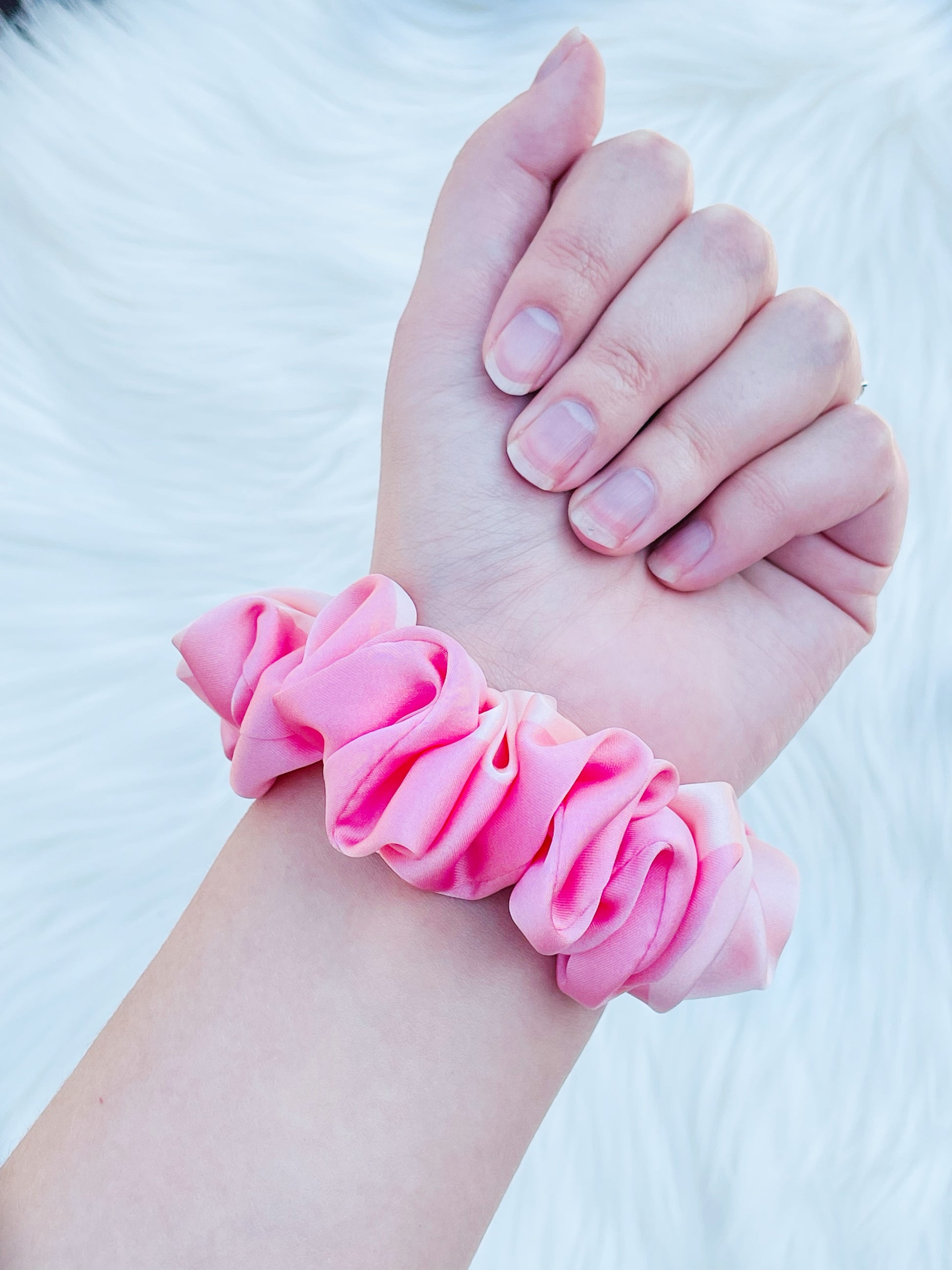 CAROLINA MINI | EMI AND CO | mini pink satin scrunchie on wrist 