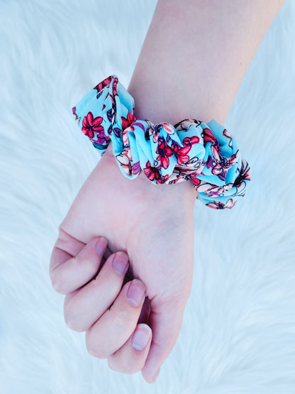 NEVAEH MINI|EMI AND CO |mini blue and red floral scrunchie on wrist 