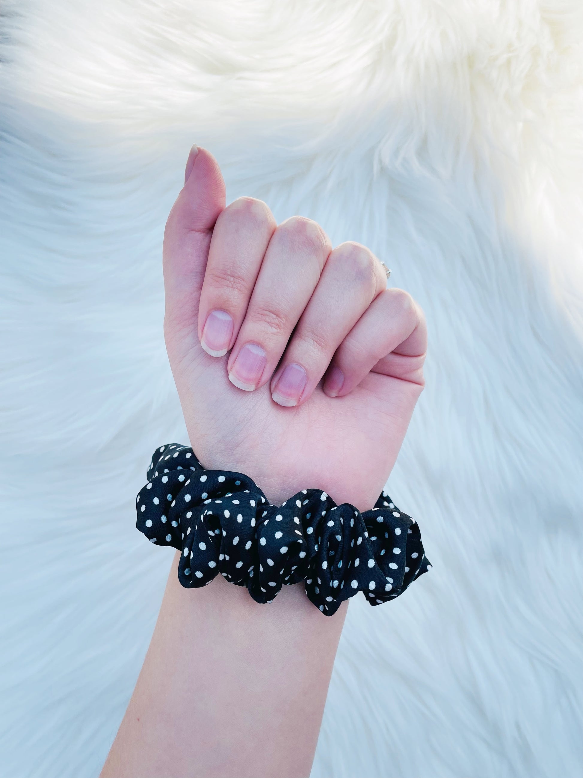 LEILANI MINI |EMI AND CO | mini black satin polka dot scrunchie on wrist 