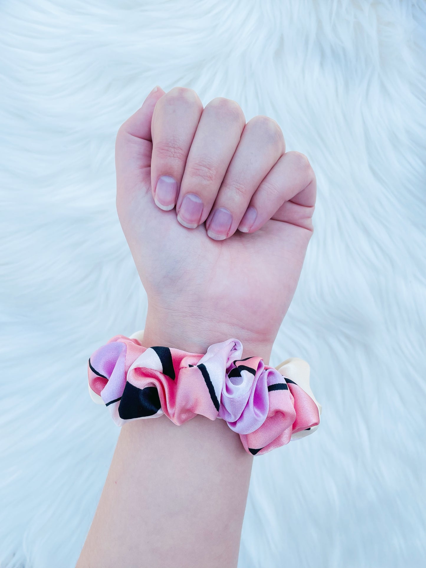 SCOUT MINI| EMI AND CO |mini pink pattern satin scrunchie on wrist 