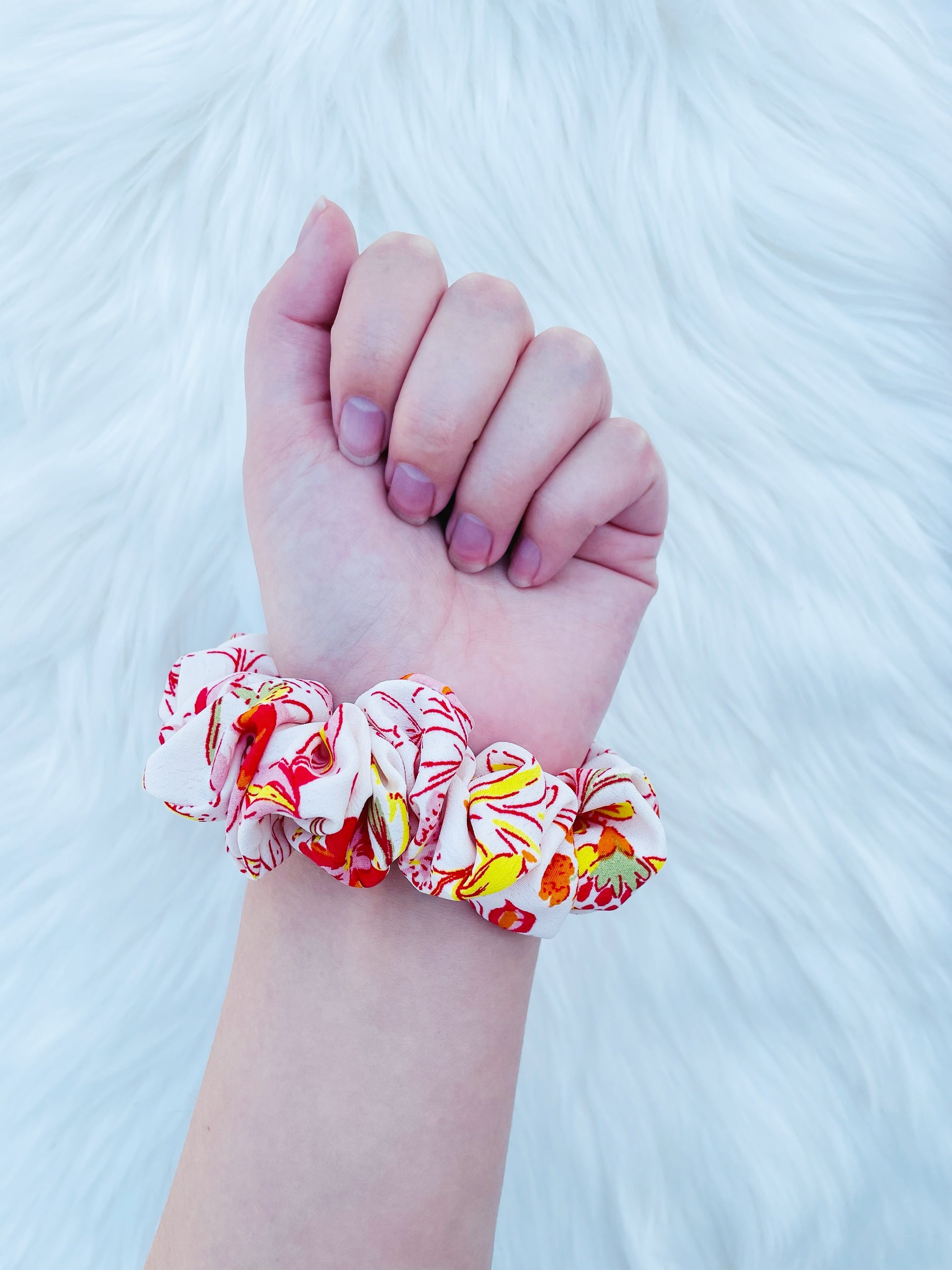 POPPY MINI|EMI AND CO| Mini white and orange floral scrunchie on wrist 