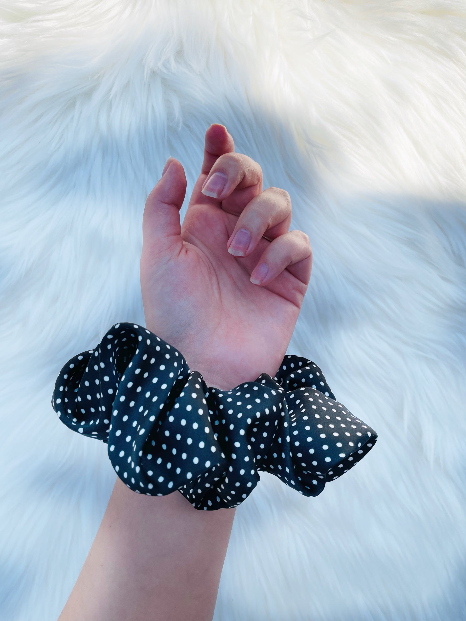 LEILANI |EMI AND CO | black satin polka dot scrunchie on wrist 