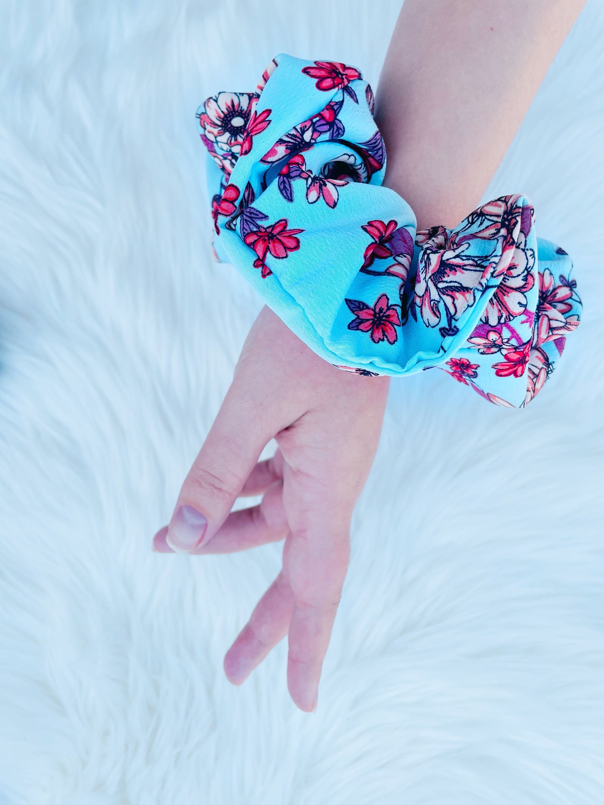 NEVAEH|EMI AND CO | blue and red floral scrunchie on wrist 