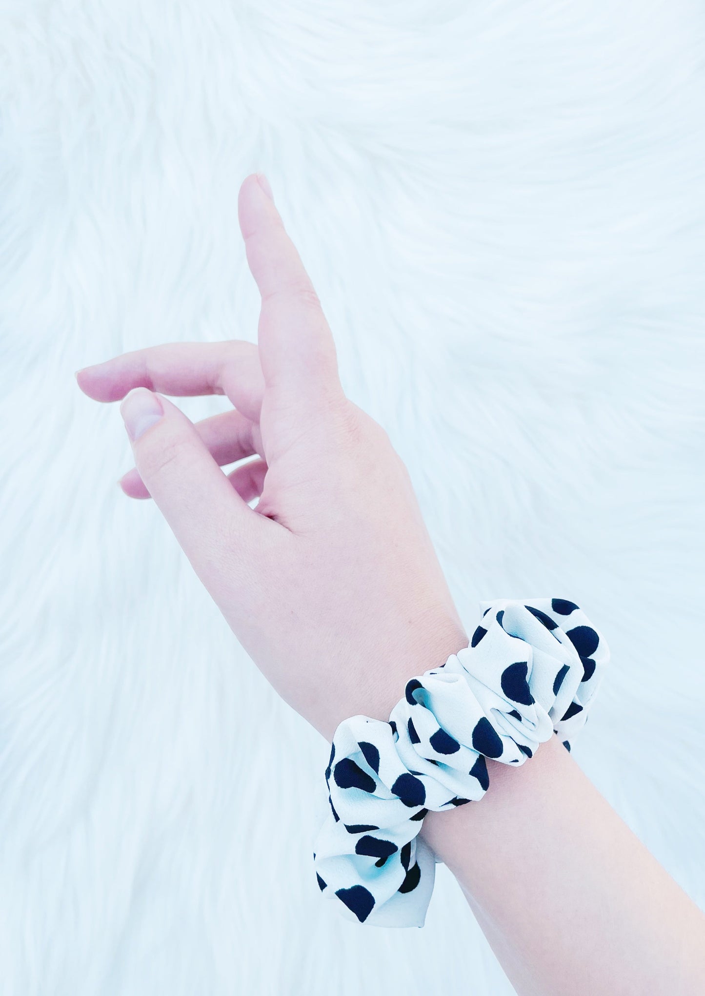 ANGELINA MINI | EMI AND CO | mini black and white polka dot scrunchie on wrist. 