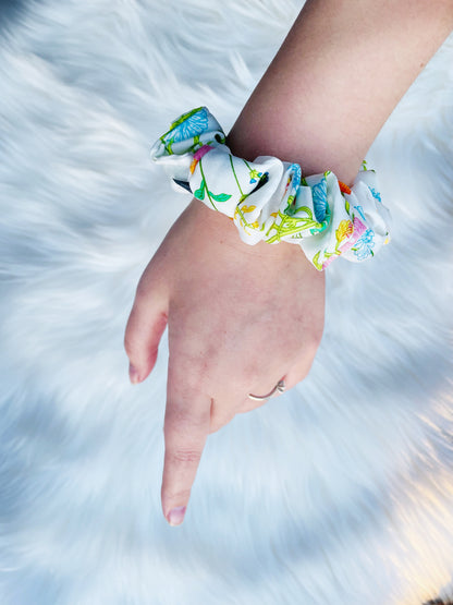 KAYA MINI | EMI AND CO | mini orange, green yellow floral scrunchie on wrist 