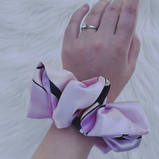 SCOUT MINI| EMI AND CO |mini pink pattern satin scrunchie on wrist 