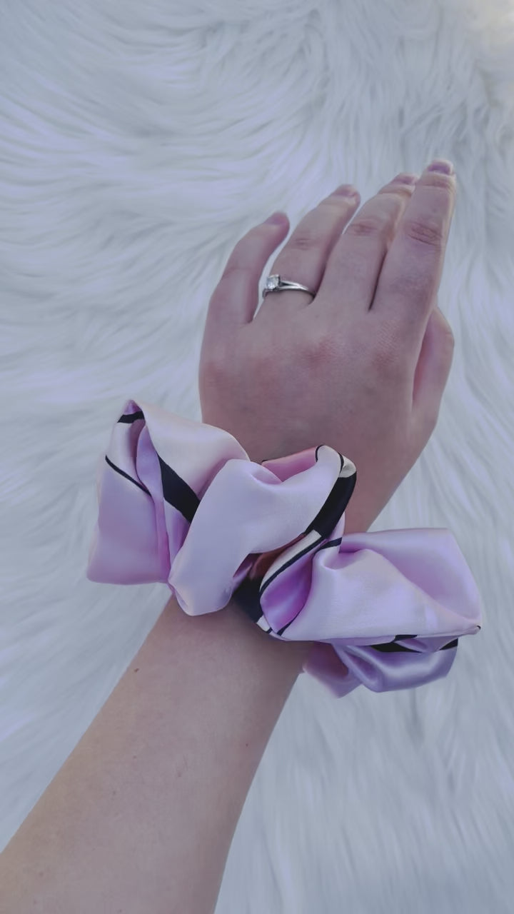 SCOUT MINI| EMI AND CO |mini pink pattern satin scrunchie on wrist 