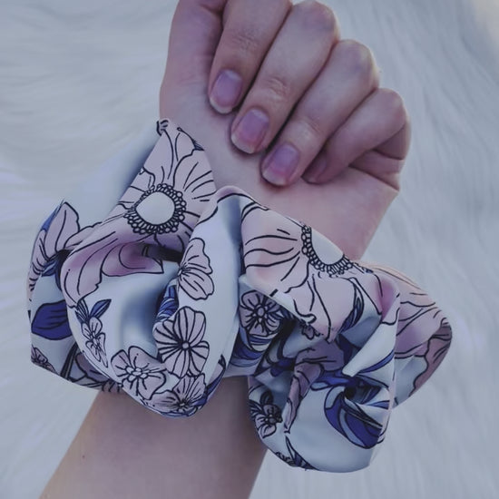 EMALINE| EMI AND CO | floral pink and blue satin scrunchie on wrist 