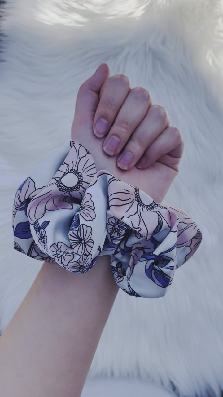 EMALINE| EMI AND CO | floral pink and blue satin scrunchie on wrist 