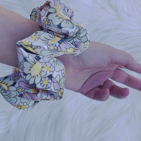 REAGAN| EMI AND CO | floral pink and green scrunchie on wrist 