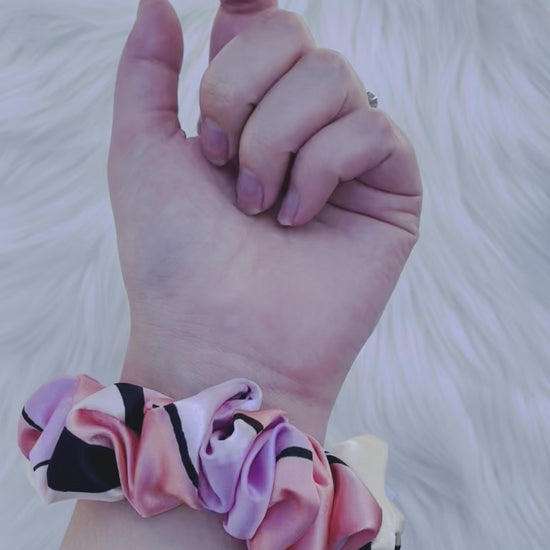 SCOUT MINI| EMI AND CO |mini pink pattern satin scrunchie on wrist 