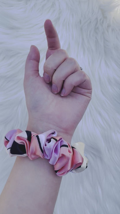 SCOUT MINI| EMI AND CO |mini pink pattern satin scrunchie on wrist 