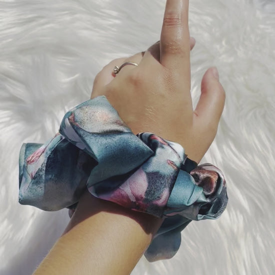BLOSSOM| EMI AND CO | blue floral satin scrunchie on wrist 