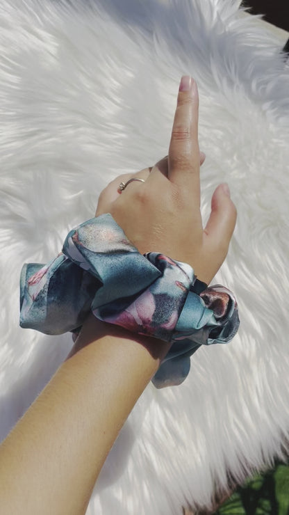 BLOSSOM| EMI AND CO | blue floral satin scrunchie on wrist 