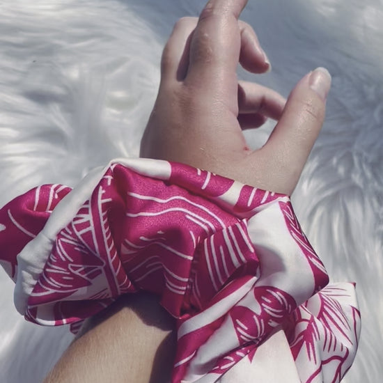 ITZAYANA| EMI AND CO | Pink and white floral satin scrunchie on wrist 