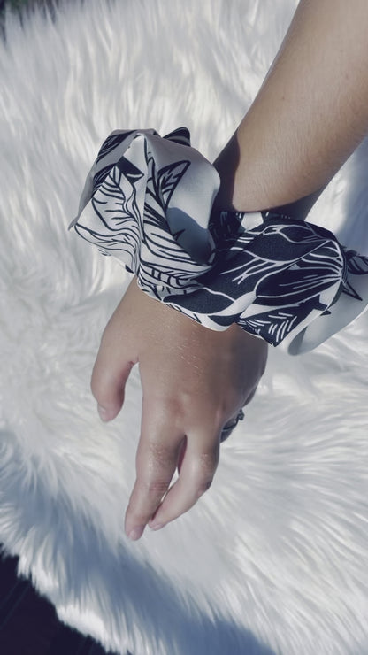 BAMBI | EMI AND CO | floral satin black and white scrunchie  on wrist 