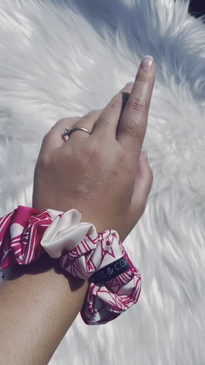 ITZAYANA| EMI AND CO | Pink and white floral satin scrunchie on wrist 