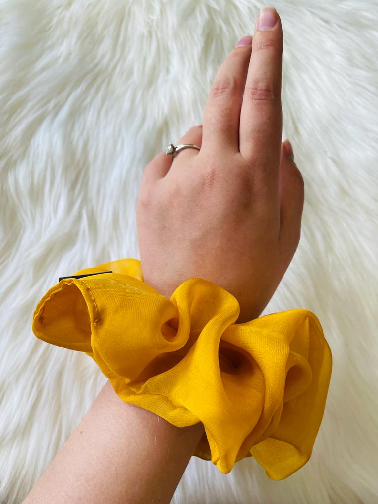 oversized yellow chiffon scrunchie on wrist | EMI & CO | olivia 