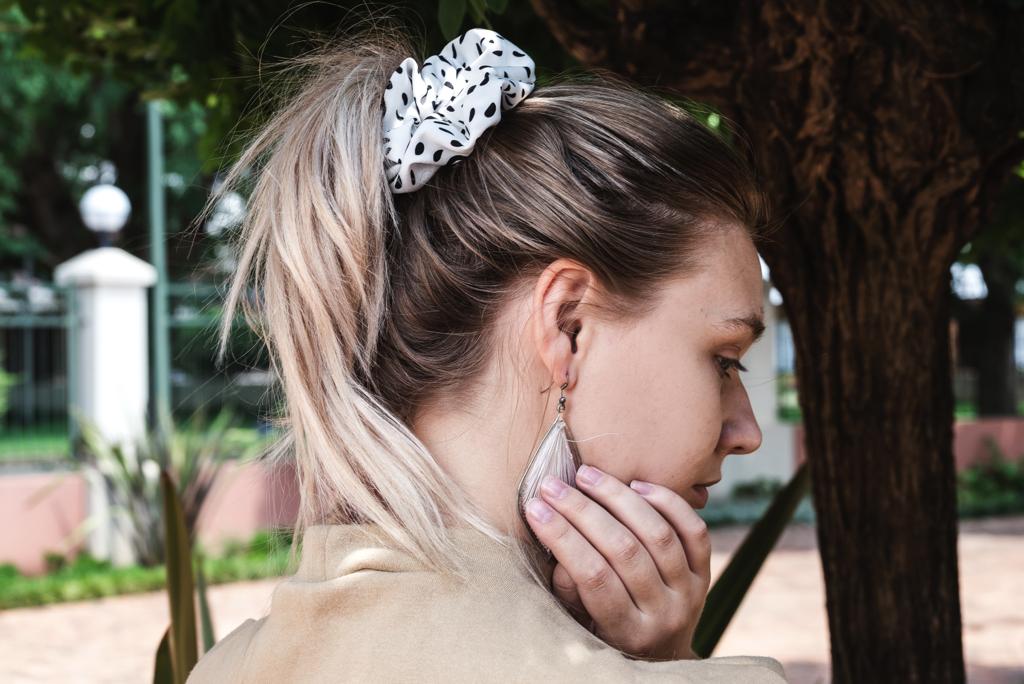 ANGELINA | EMI & CO | woman with a white polka dot scrunchie in hair