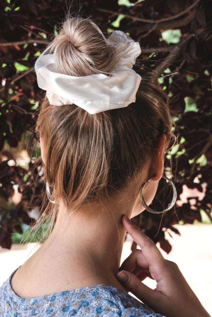 DESTINY | EMI & CO | woman with messy bun in white satin scrunchie