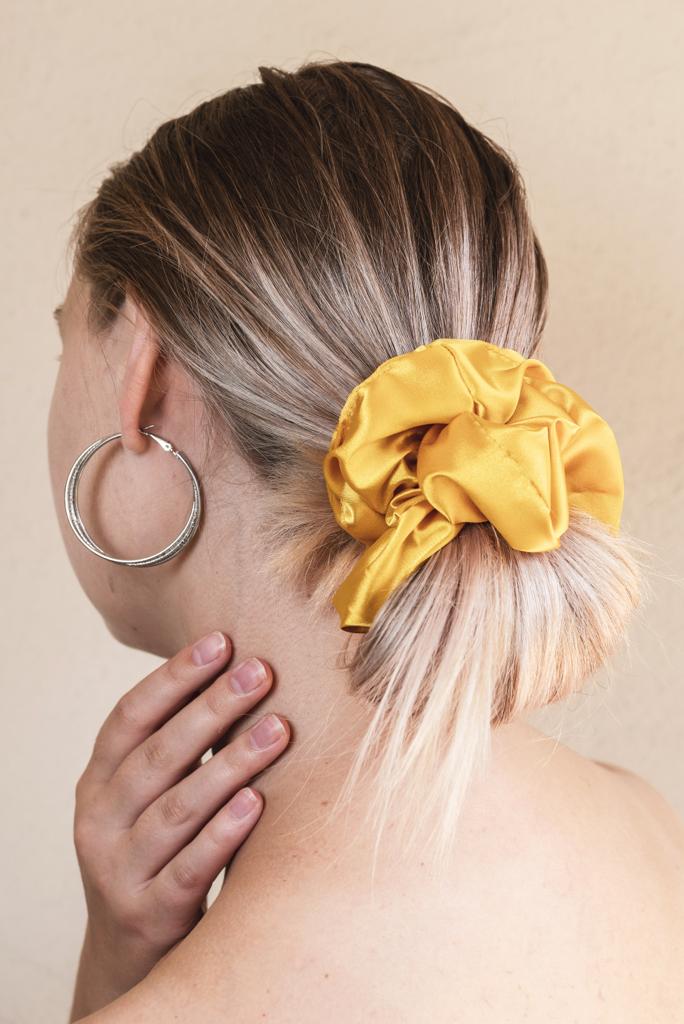 AUTUMN | EMI & CO | woman with a low messy bun in a yellow scrunchie 