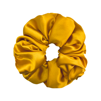 AUTUMN | EMI & CO |a messy bun in a yellow satin scrunchie