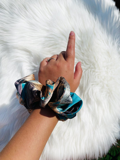 QUEENIE| EMI AND CO | blue and gold satin scrunchie on wrist 