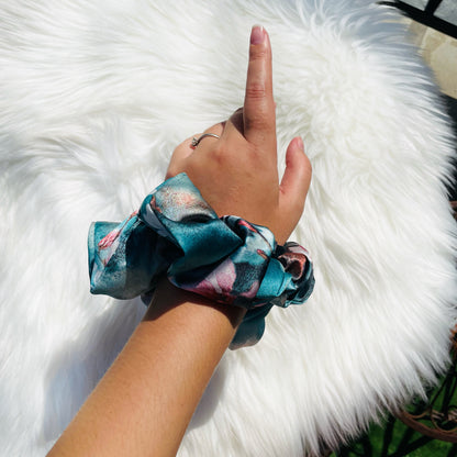 BLOSSOM| EMI AND CO | blue satin floral scrunchie on wrist 