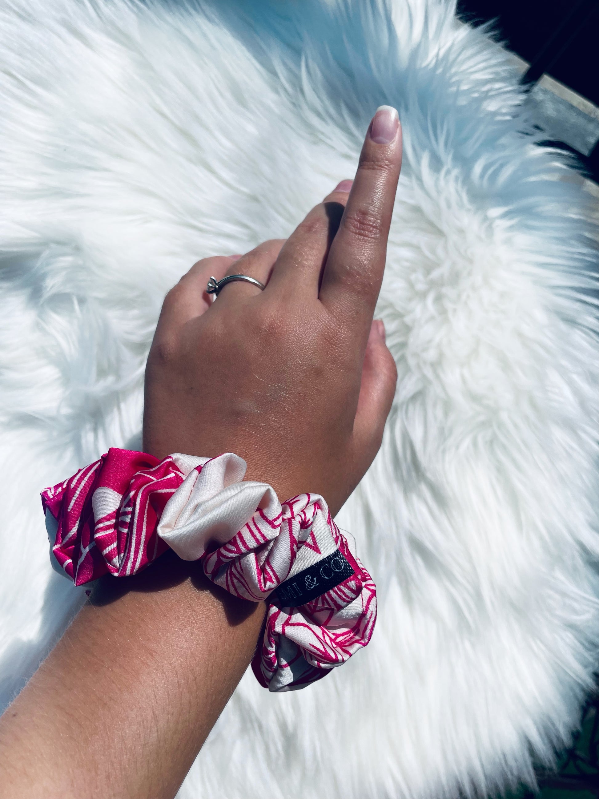 ITZAYANA| EMI AND CO | Pink and white floral satin scrunchie on wrist 