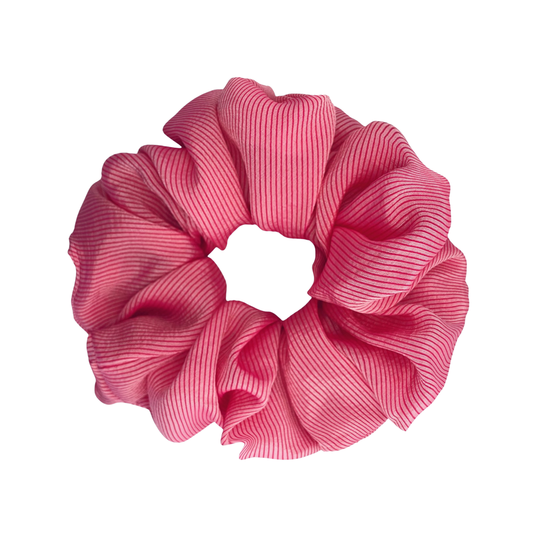 AVERY | EMI & CO |  a messy low bun in a pink scrunchie